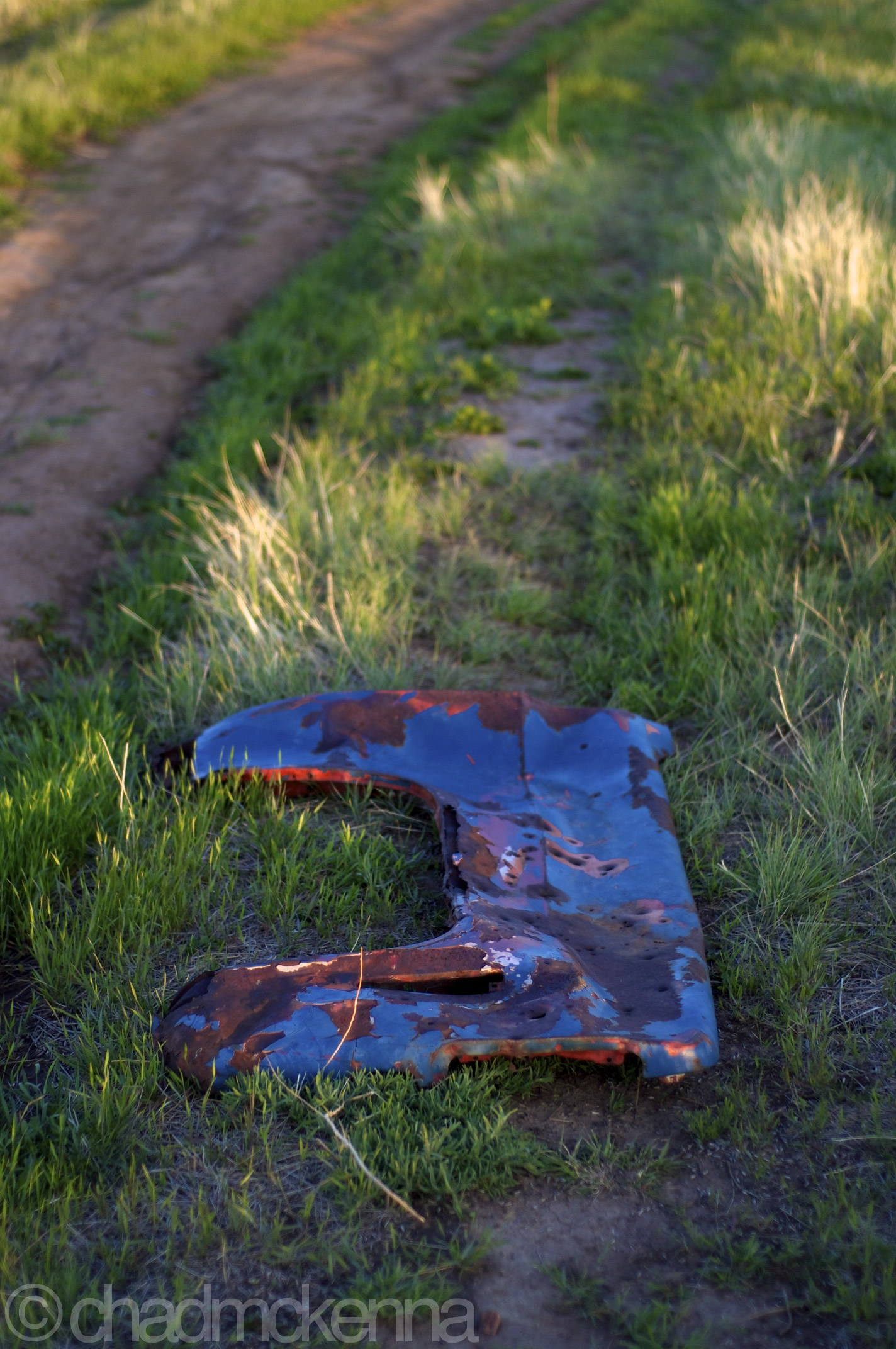A bullet ridden car part. (Nikkor 50mm, 1/1250, F/1.8, -1 ev, ISO 200 on D5000)