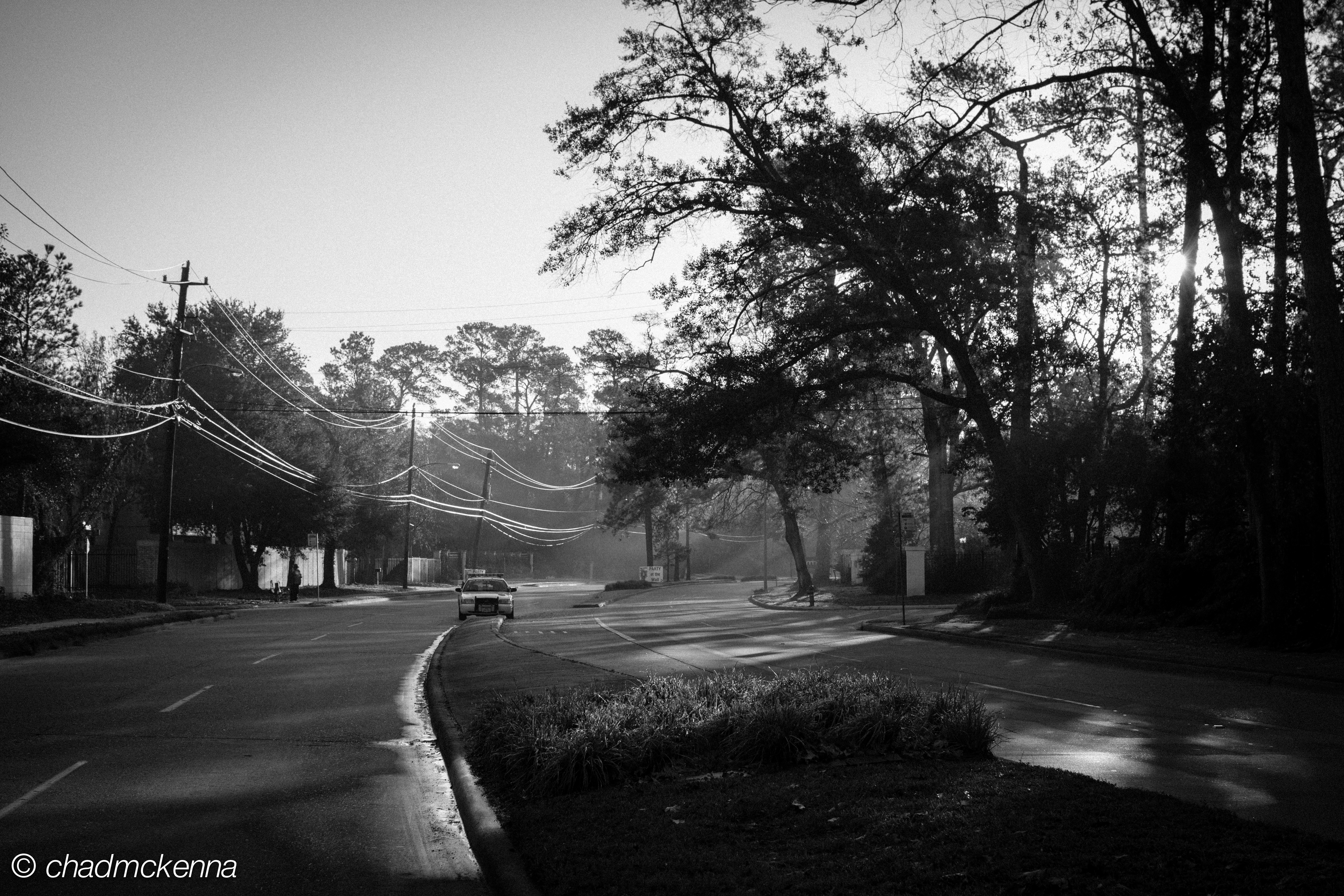 A cop car stopped in the middle of the road on Memorial Drive