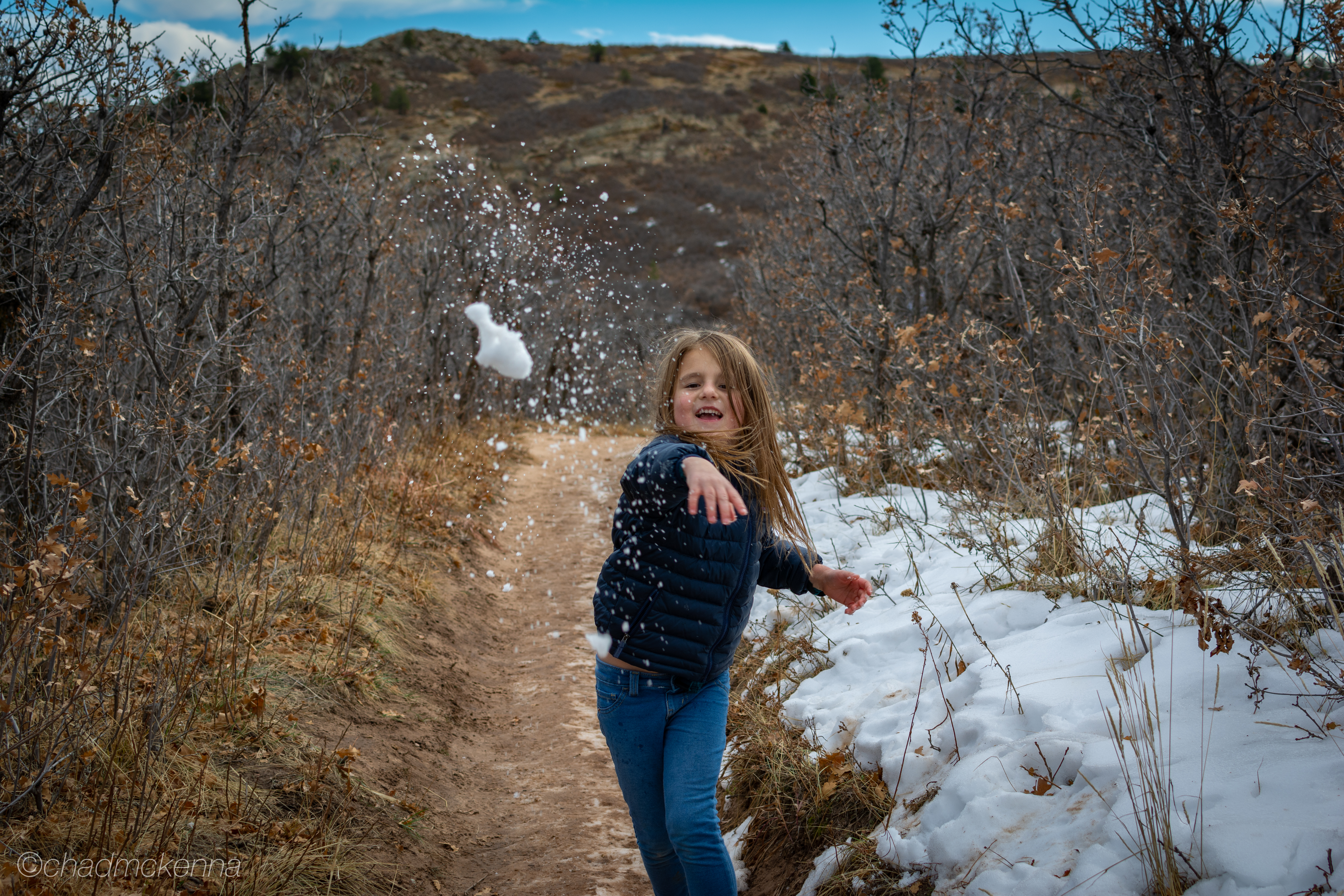 Ava throwing snowballs